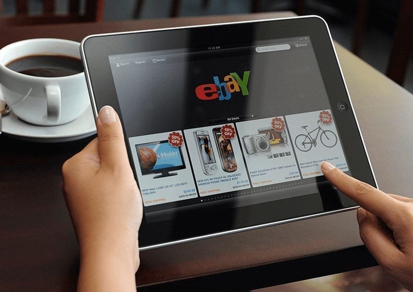 Ebay being used on a tablet with coffee cup in the background