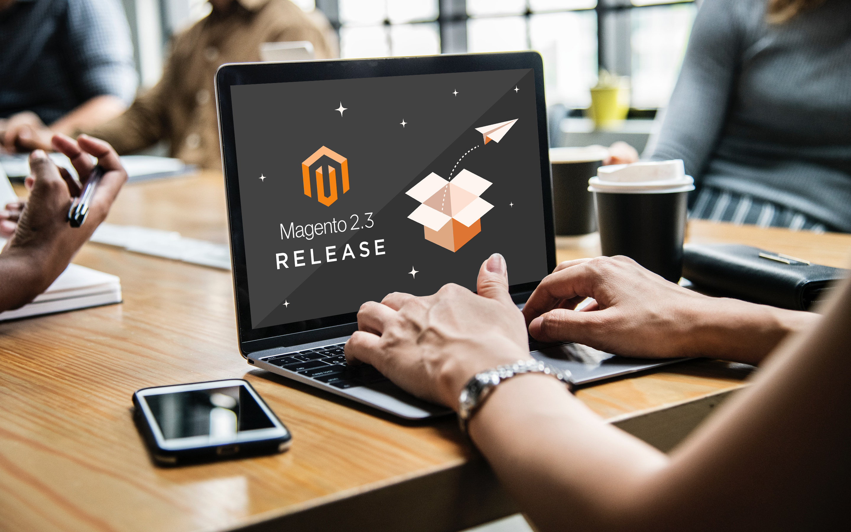 Magento 2.3 Release splashscreen, on a laptop on a wooden table