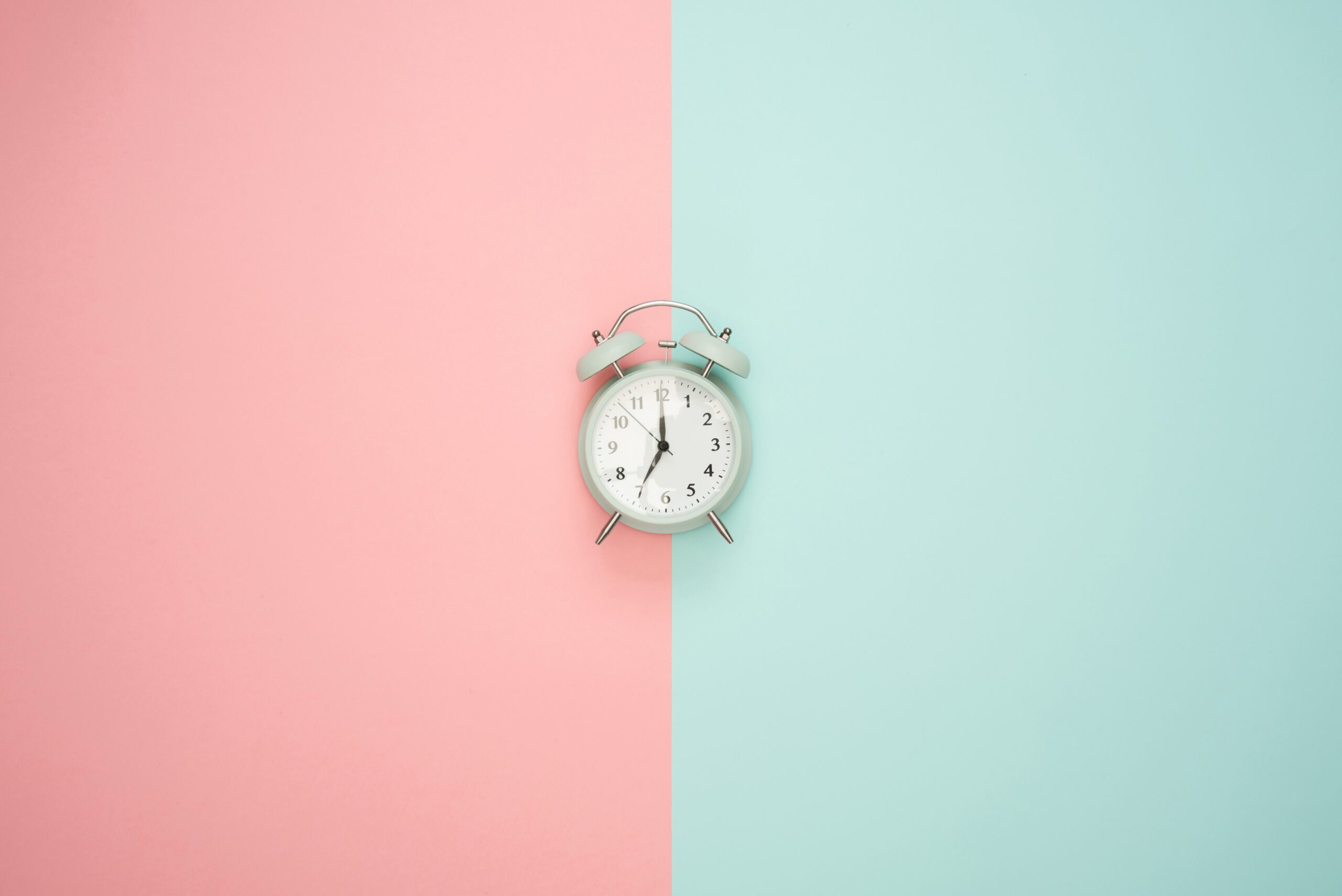 Alarm clock between light blue and light pink panels