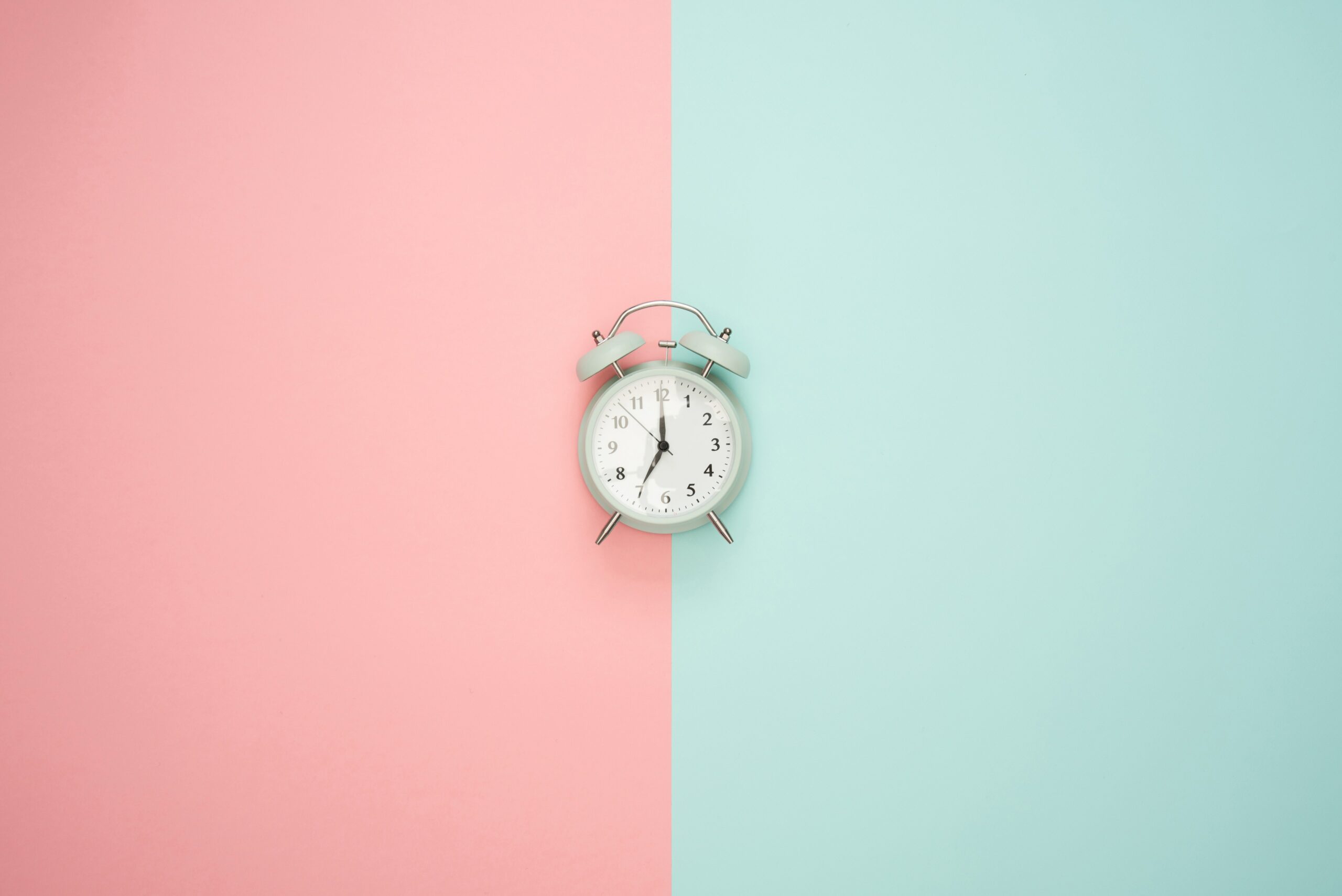 Alarm clock between light blue and light pink panels