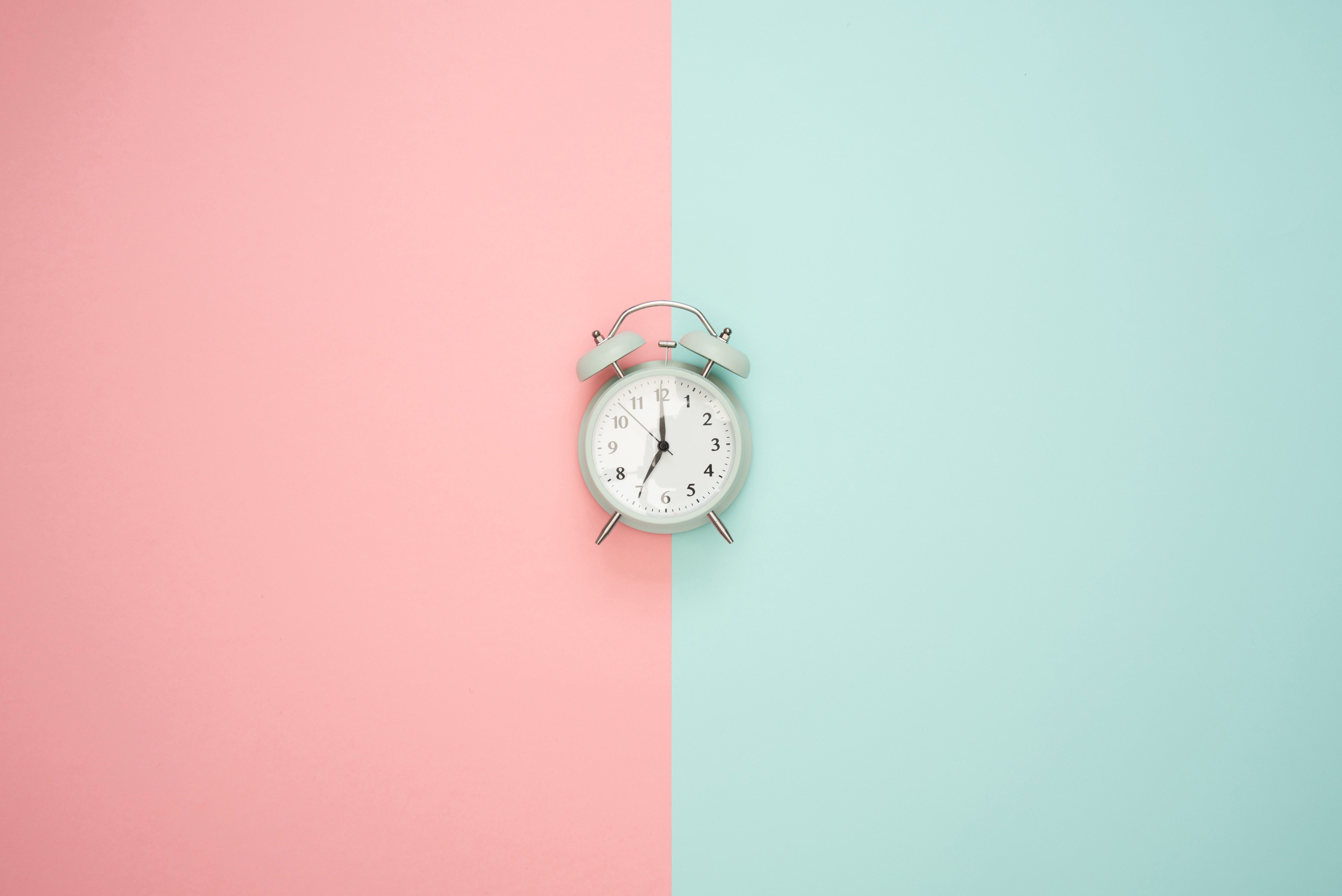 Alarm clock between light blue and light pink panels