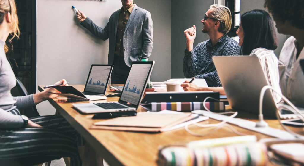 Numerous poeple at a brainstorming session in boardroom