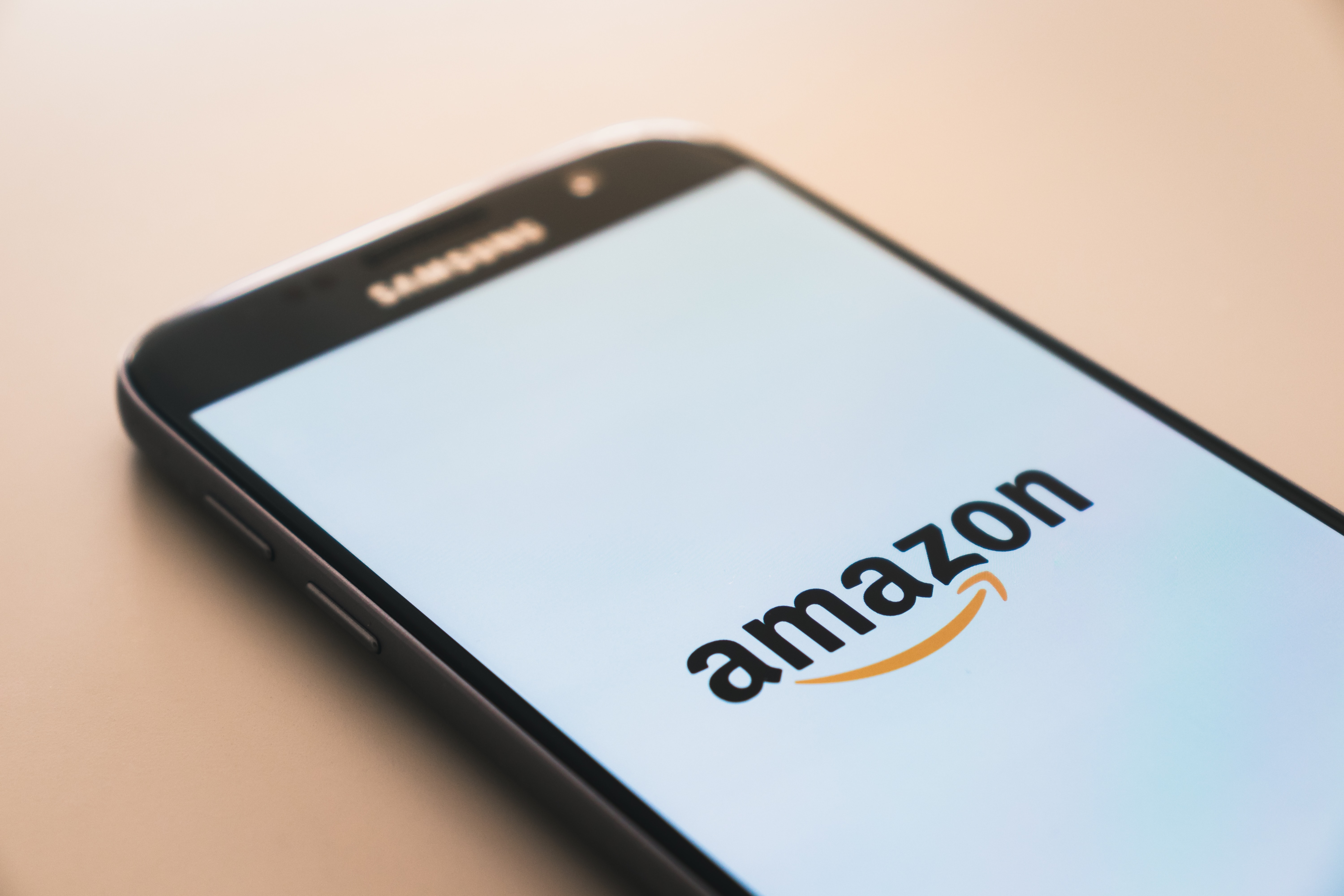 the Amazon app loading on a mobile phone for a customer journey to begin