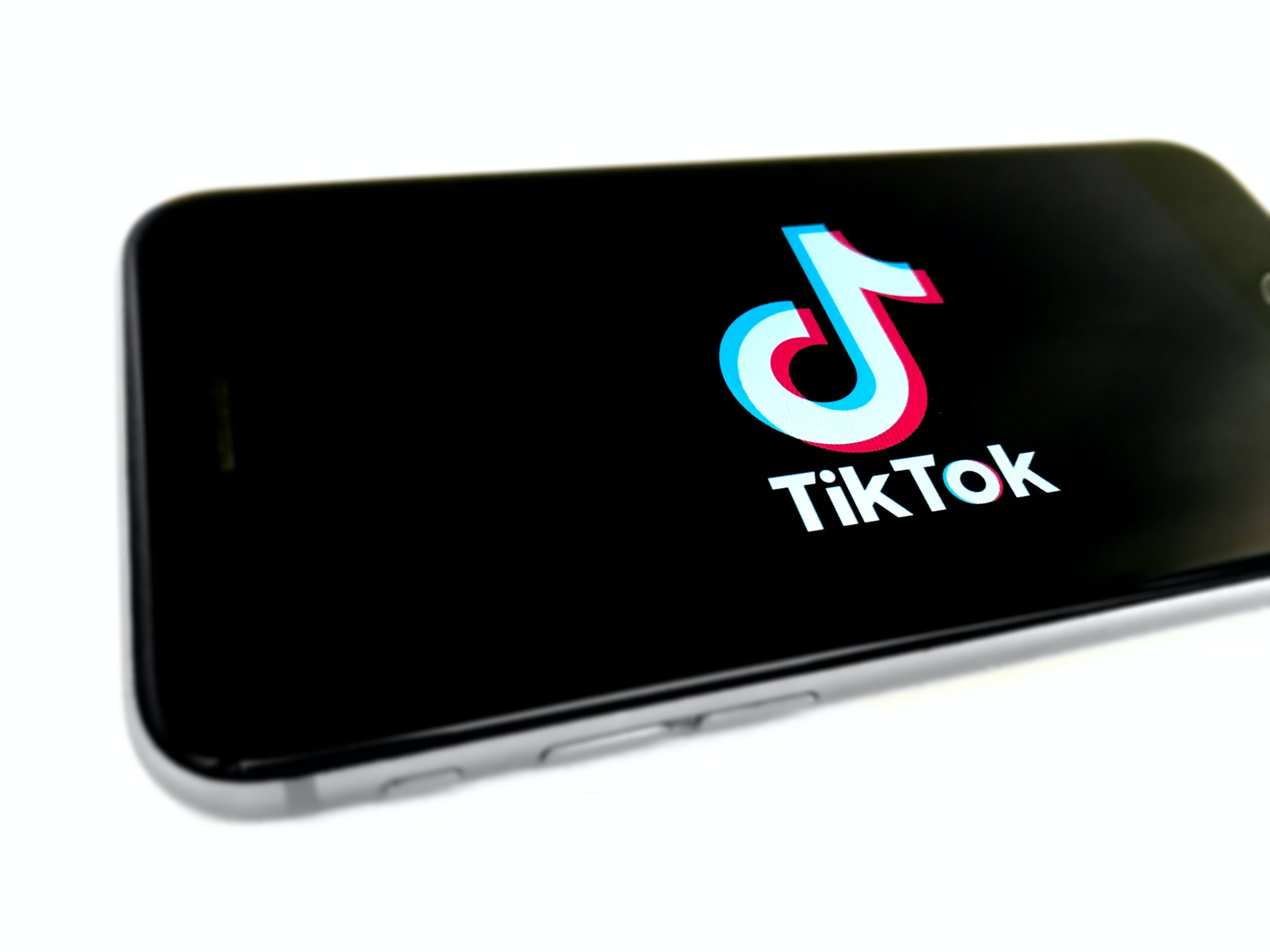 A mobile phone with TikTok logo on the screen