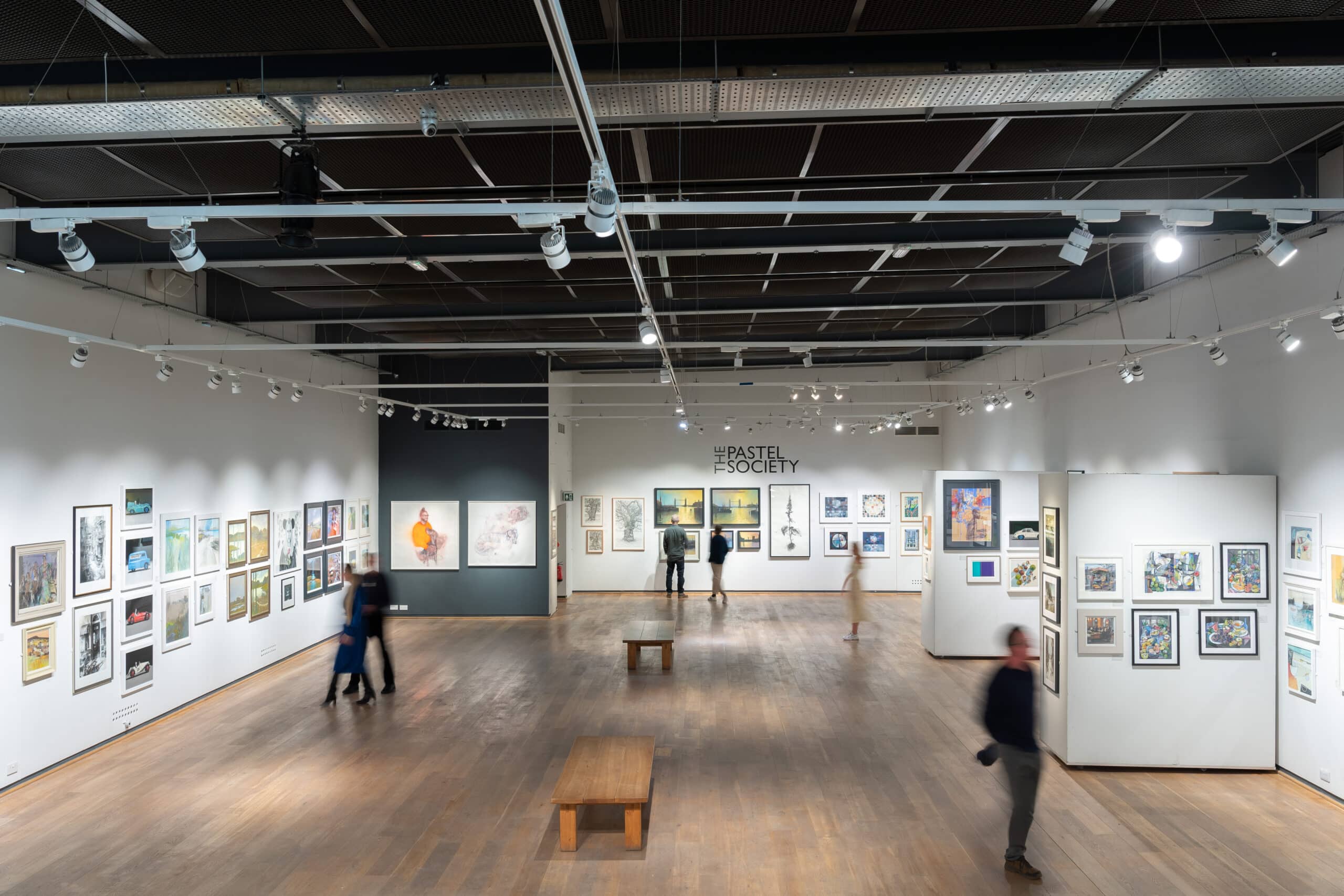 Visitors viewing art in Mall Galleries