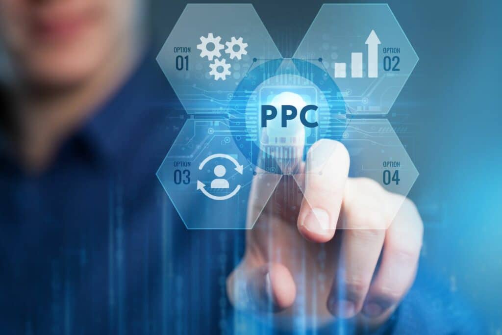 Person pointing to a blue screen with 'PPC' and graph icons surrounding this.