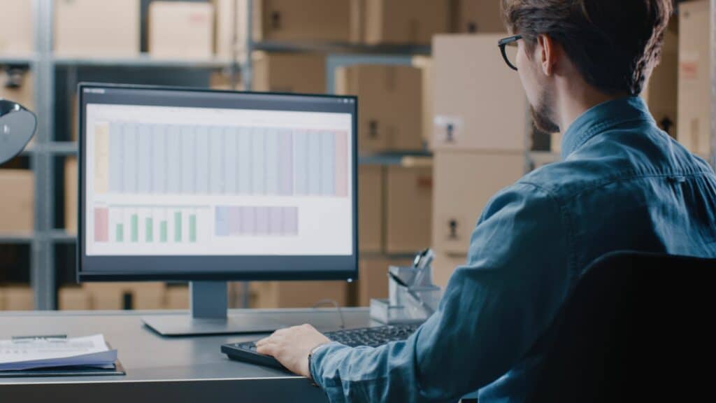 a man managing inventory on computer