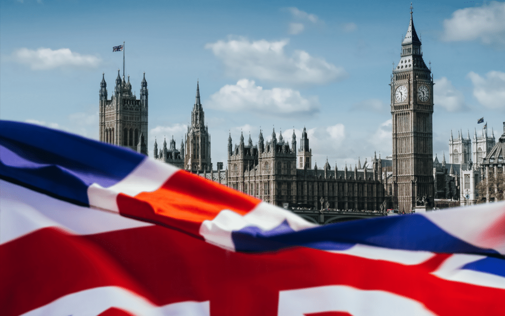 united Kingdom flag with houses of parliament in the background